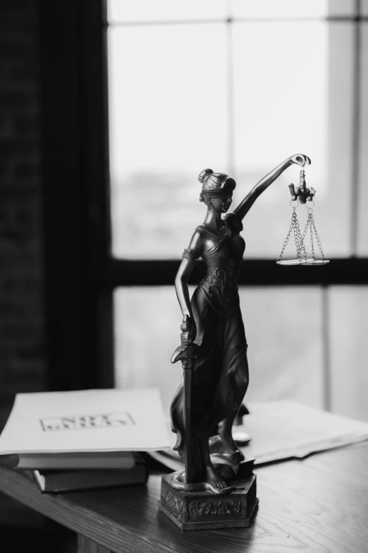 a statue of lady justice holding a scale, by Niko Henrichon, pexels contest winner, black-and-white, miniature photography, paper, dunce