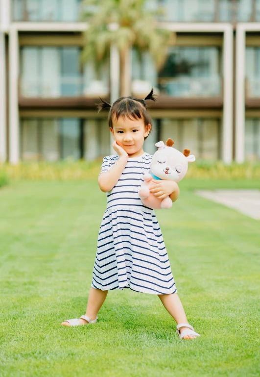 a little girl in a striped dress holding a teddy bear, inspired by Cui Bai, unsplash, square, premium quality, full body photo, asia