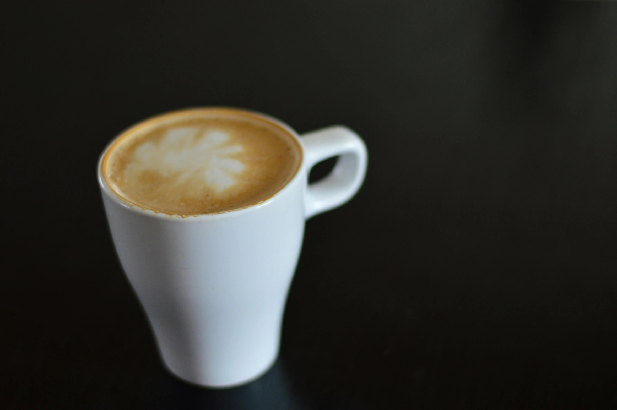 a close up of a cup of coffee on a table, paul barson, very pale, thumbnail, fan favorite