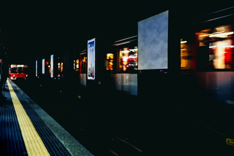 a train pulling into a train station at night, a picture, unsplash, graffiti, many screens, 2 5 6 x 2 5 6 pixels, mrt, in a row