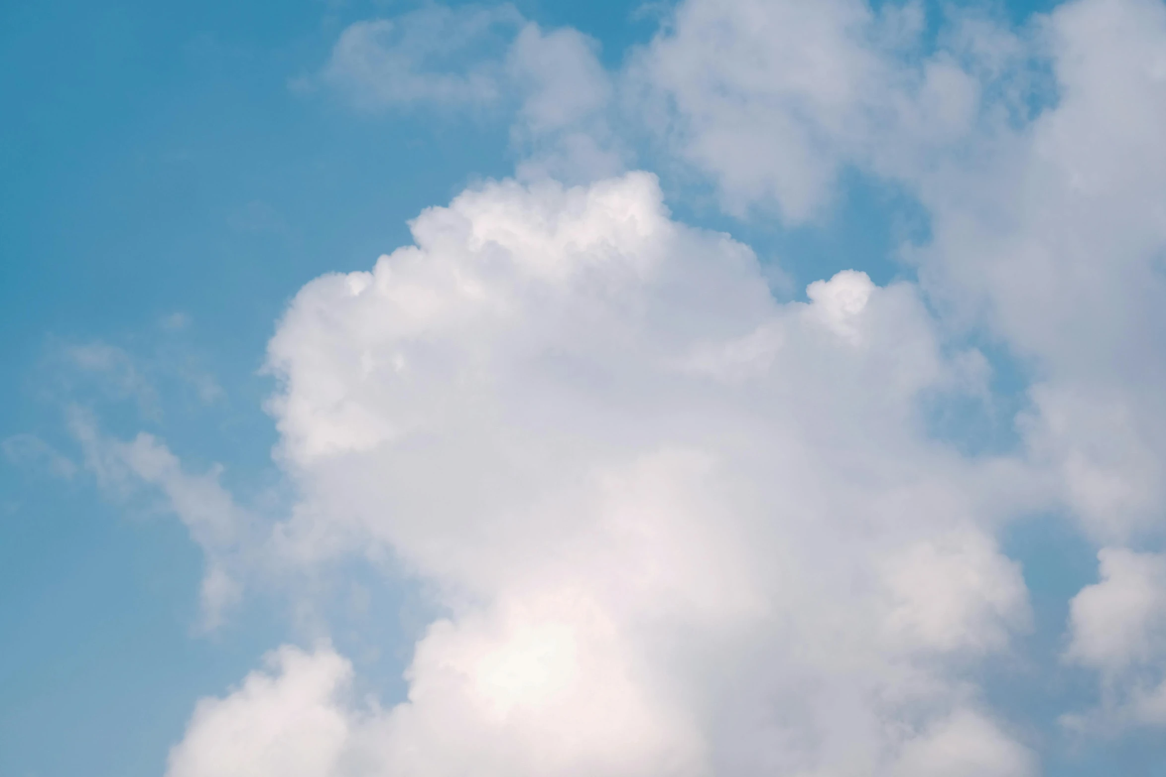 a man flying a kite on top of a lush green field, unsplash, giant cumulonimbus cloud, light blues, instagram post, detailed high resolution