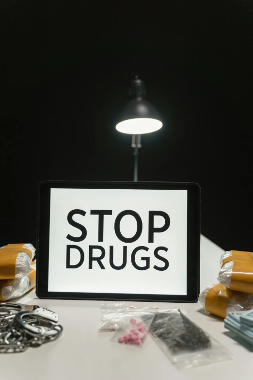 a tablet computer sitting on top of a table, by Everett Warner, pexels, graffiti, drugs, stop sign, a labeled, official screenshot