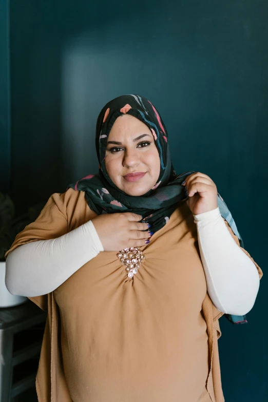 a woman in a hijab poses for a picture, an album cover, pexels contest winner, overweight, confident smirk, brown, large)}]