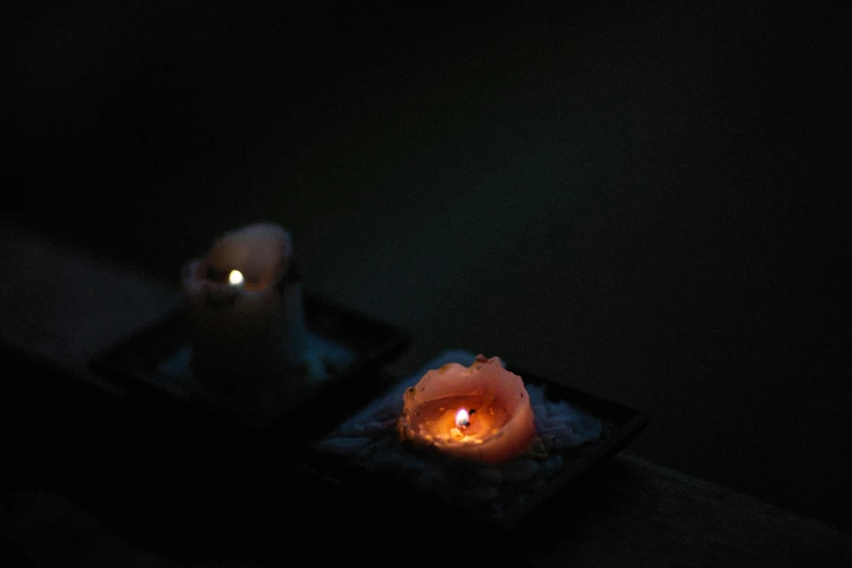 a lit candle sitting on a tray in the dark, by Elsa Bleda, floating lanterns, made of glowing wax and ceramic, miniature product photo, battered