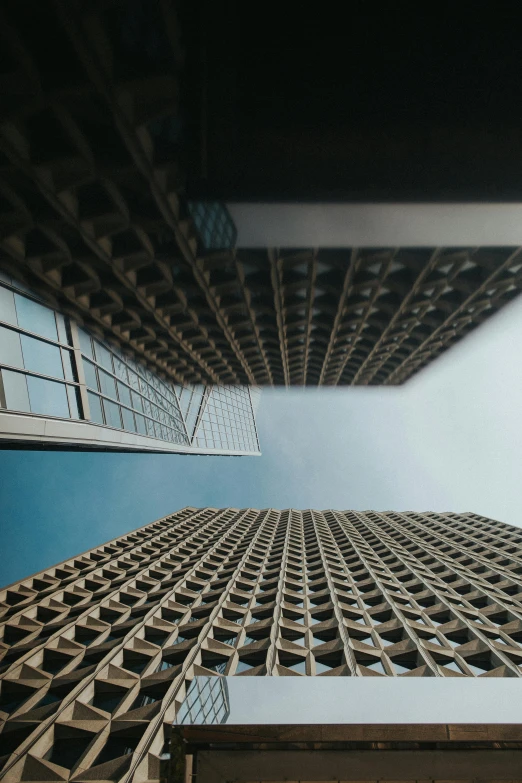 a tall building with a blue sky in the background, by Adam Rex, pexels contest winner, square lines, two organic looking towers, top down perspecrive, looking in front