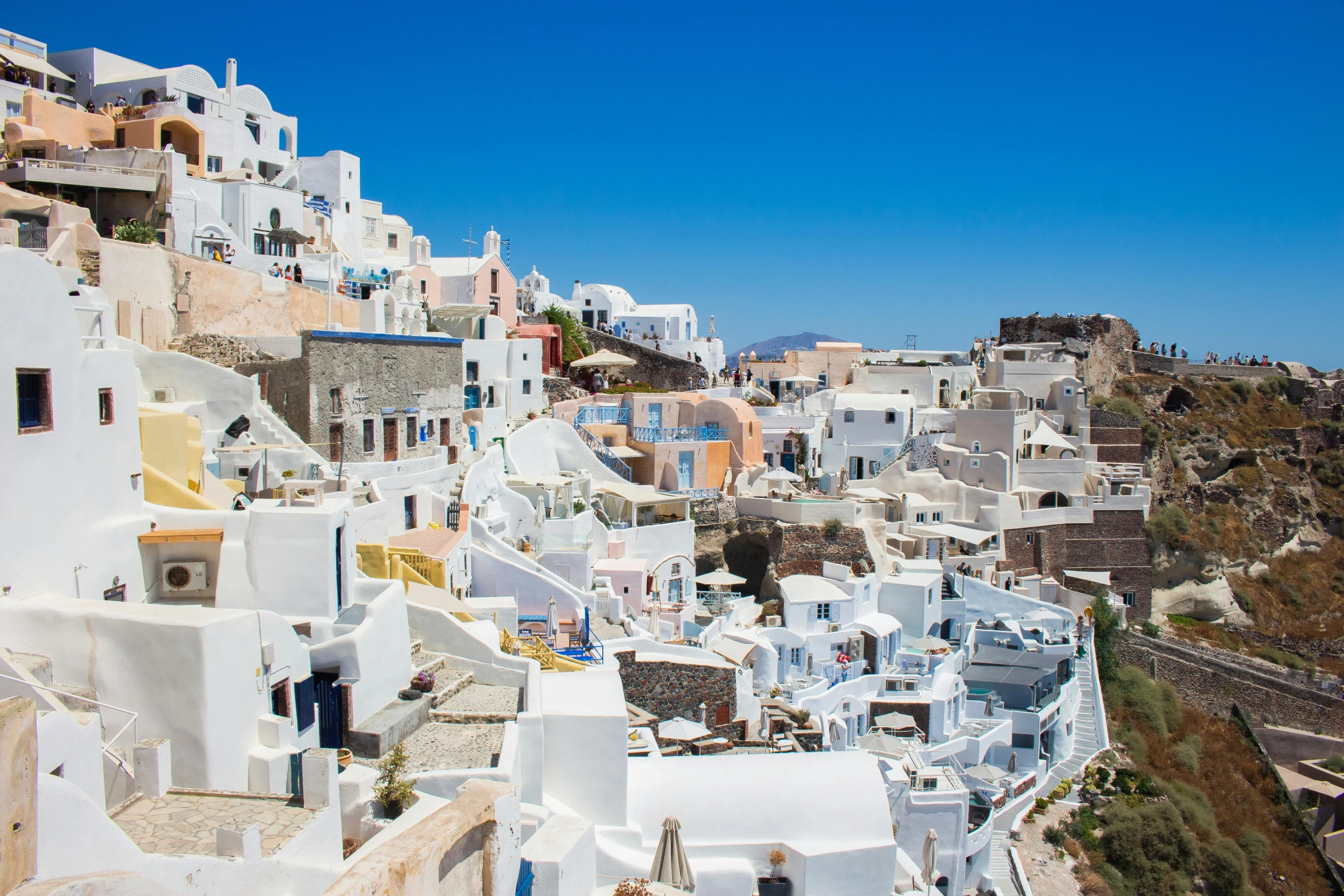 a view of the town of oia on the greek island of santo, pexels contest winner, neoclassicism, avatar image, full body image, white and pale blue, frank gehry