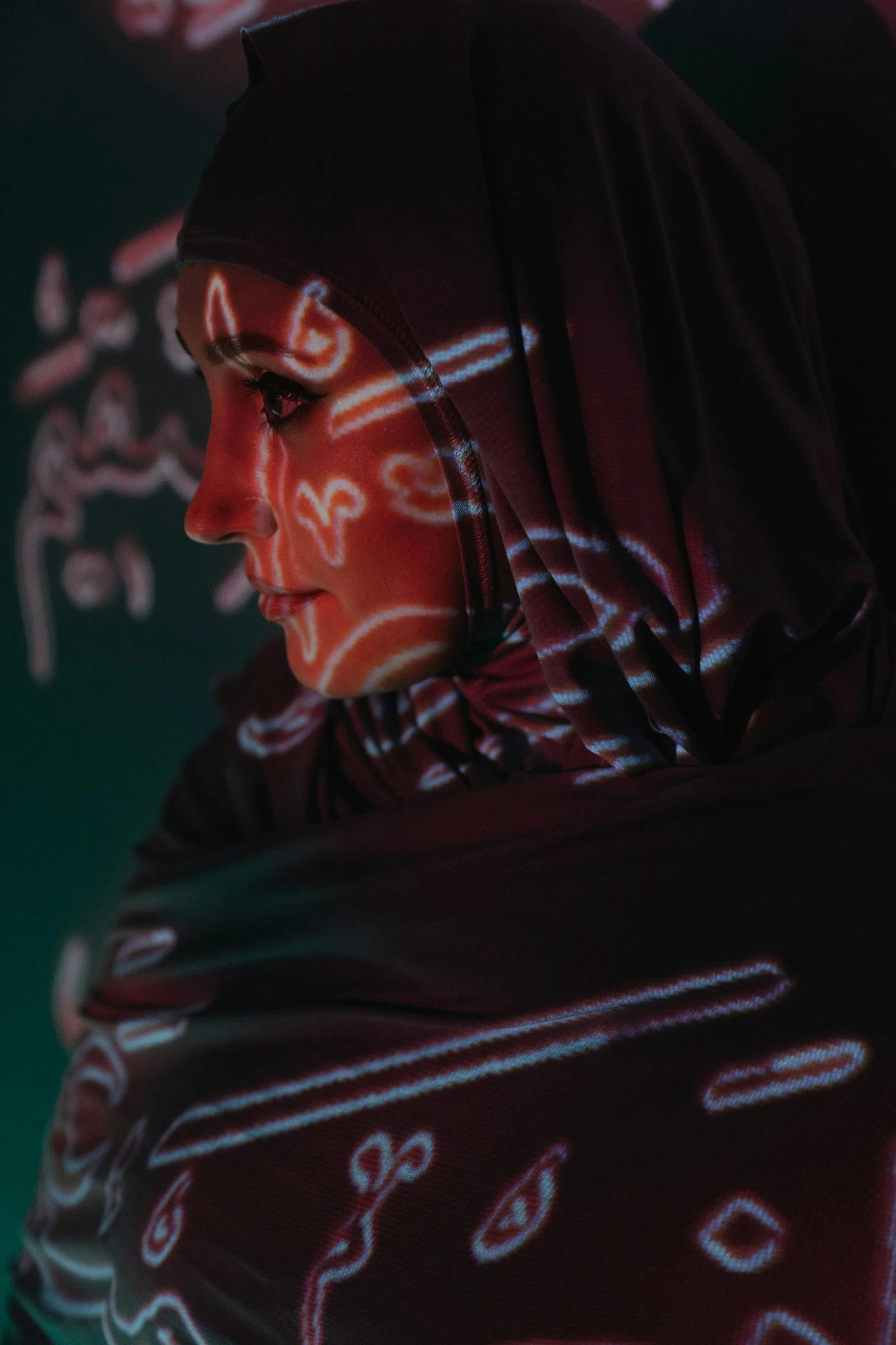 a close up of a person wearing a scarf, by Maryam Hashemi, holography, glowing ceremonial markings, ( ( theatrical ) ), mathematical, arab inspired