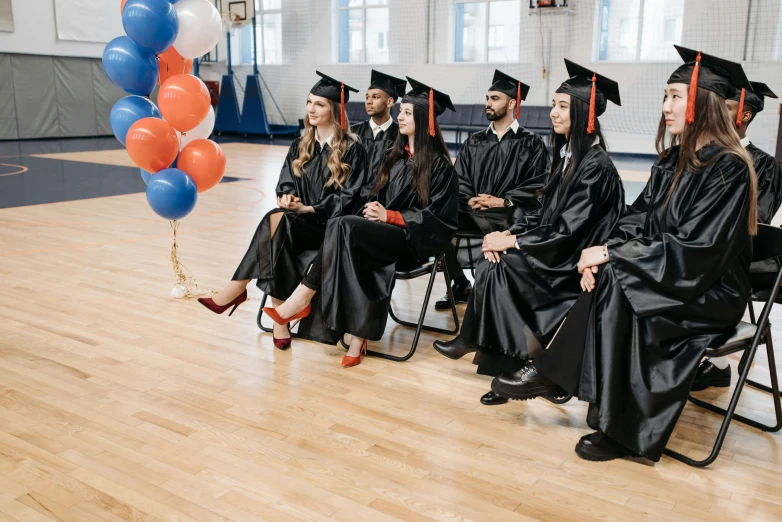 a group of people in graduation gowns sitting in chairs, pexels, balloons, sitting on the floor, american school, russian academic