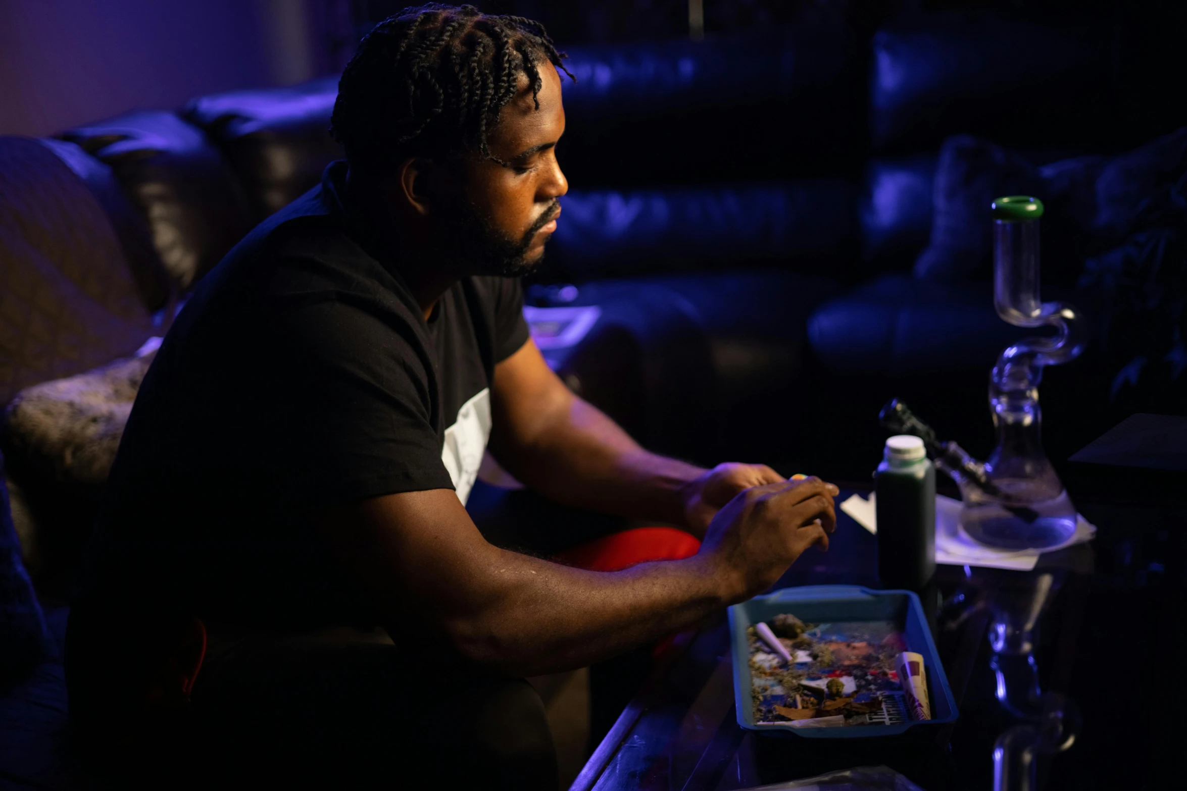 a man sitting at a table with a tray of food, process art, kayne west, playing board games, low lighting, profile image