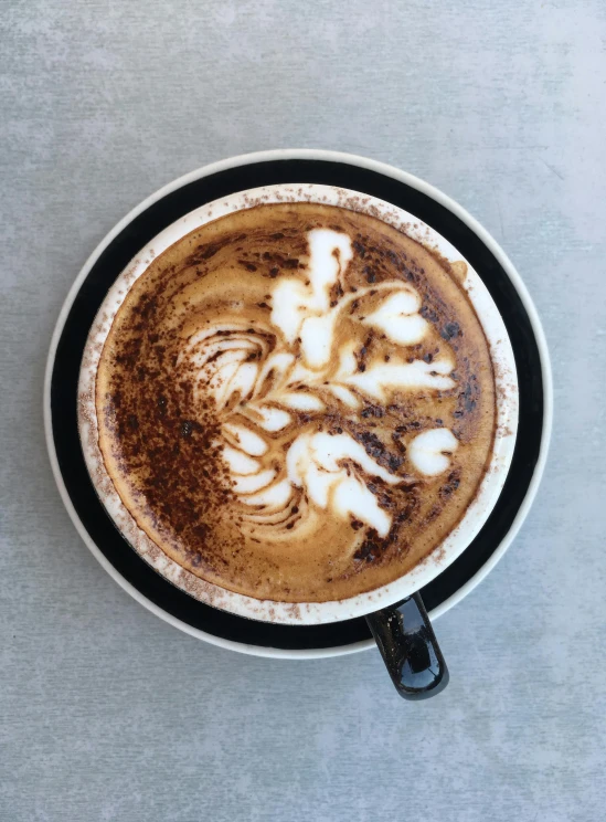 a close up of a cup of coffee on a table, profile image, fully decorated, aussie baristas, top down view