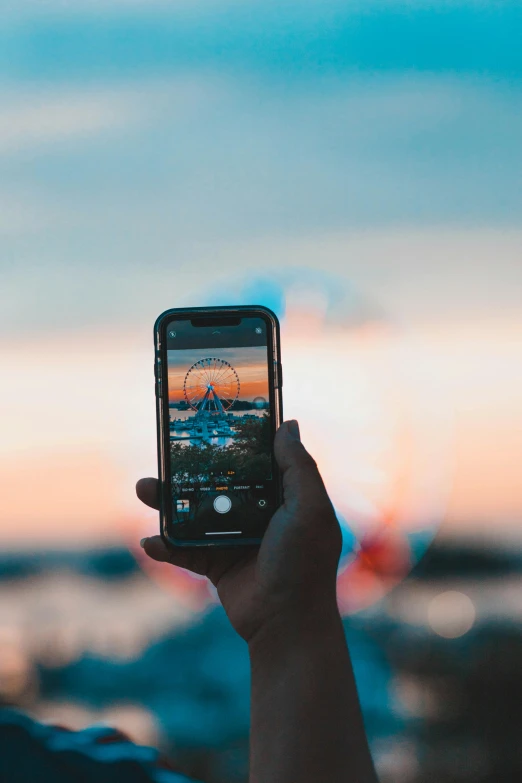 a person taking a picture with their cell phone, a picture, pexels contest winner, space ship in the distance, iphone wallpaper, festivals, summer evening