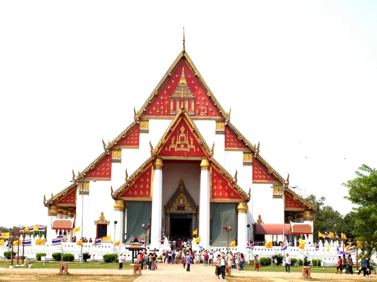 a group of people that are standing in front of a building, cloisonnism, thai temple, white buildings with red roofs, the narthex, many people worshipping