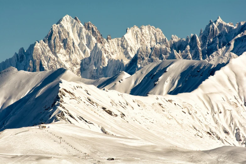 a group of people riding skis down a snow covered slope, pexels contest winner, les nabis, chiseled formations, panoramic, fine art print, two mountains in background