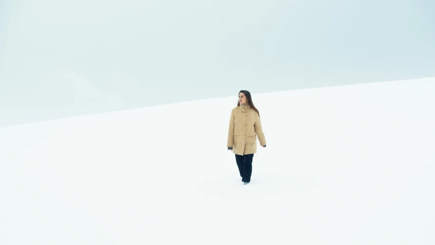 a woman walking across a snow covered field, by Matthias Weischer, unsplash, conceptual art, beige, white background : 3, blue parka, simple minimal