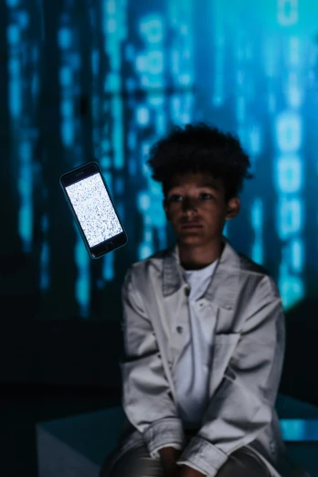 a man sitting on a bench with a cell phone in his hand, a hologram, by James Morris, pexels, black teenage boy, portrait of computer & circuits, hold up smartphone, hito steyerl