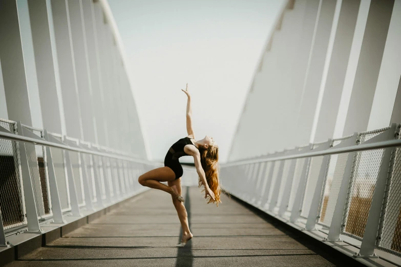 a woman in a leo leo leo leo leo leo leo leo leo leo leo leo leo leo, pexels contest winner, arabesque, sydney hanson, bridge, background image, she is dancing. realistic