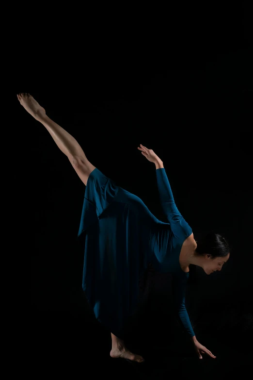 a woman in a blue dress is doing a trick, by Leo Michelson, unsplash, arabesque, on black background, square, dolman, 8l