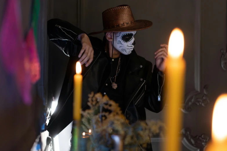 a close up of a person wearing a mask and a hat, vanitas, candle lighting, wearing samcrow leather jacket, sombrero, halloween scene