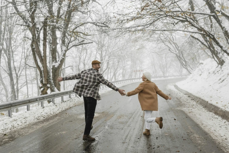 a man and a woman holding hands on a snowy road, pexels contest winner, dancing in the rain, hansel and gretel, thumbnail, white