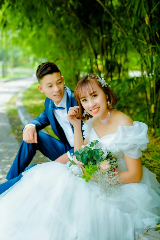 a man in a blue suit sitting next to a woman in a white dress, pexels contest winner, vietnamese woman, wearing a wedding dress, greenery, avatar image