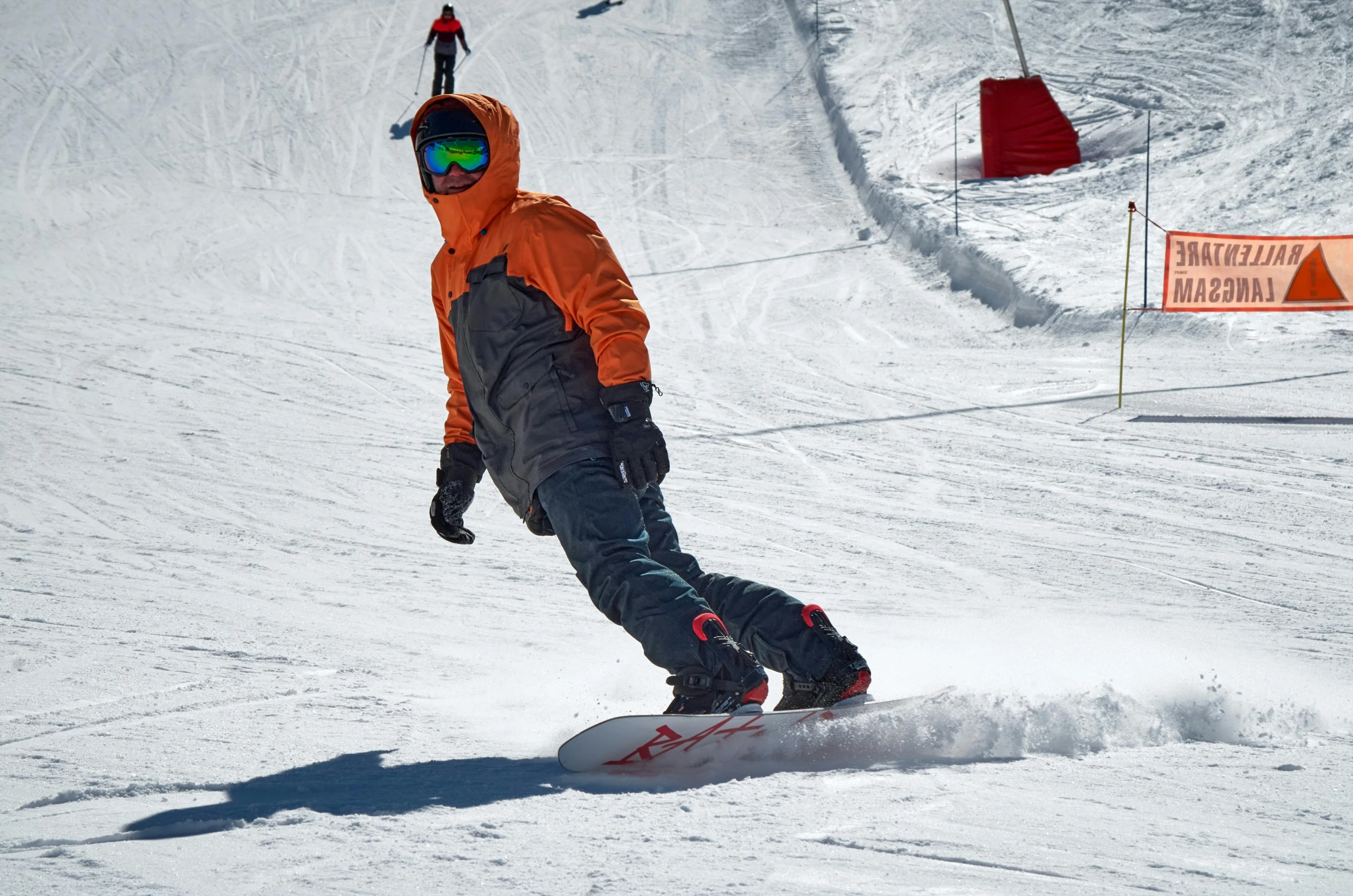a man riding a snowboard down a snow covered slope, orange balaclava, avatar image, no cropping, taken with sony alpha 9