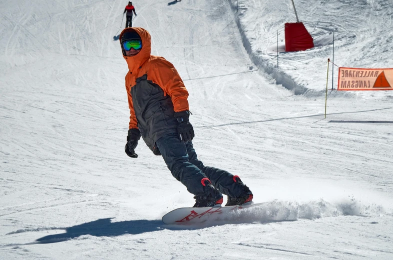 a man riding a snowboard down a snow covered slope, orange balaclava, avatar image, no cropping, taken with sony alpha 9