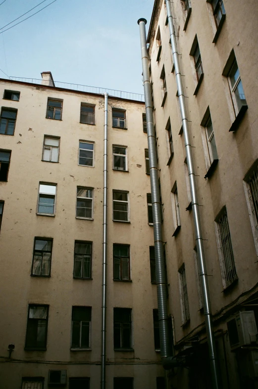 a couple of tall buildings next to each other, inspired by Josef Navrátil, renaissance, soviet yard, taken in the 2000s, old town, medium-shot