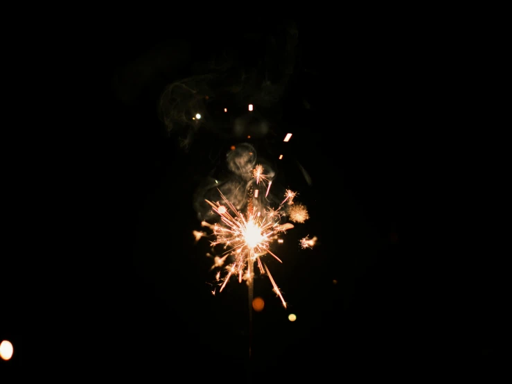 a sparkler is lit up in the dark, by Niko Henrichon, pexels, charcoal and champagne, 15081959 21121991 01012000 4k, fourth of july, 2000s photo