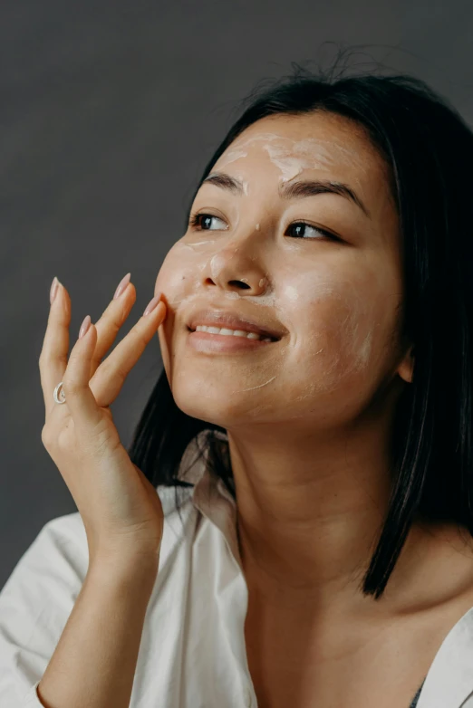 a woman with a lot of cream on her face, lineart, trending on pexels, joy ang, hands shielding face, textured base ; product photos, looking partly to the left