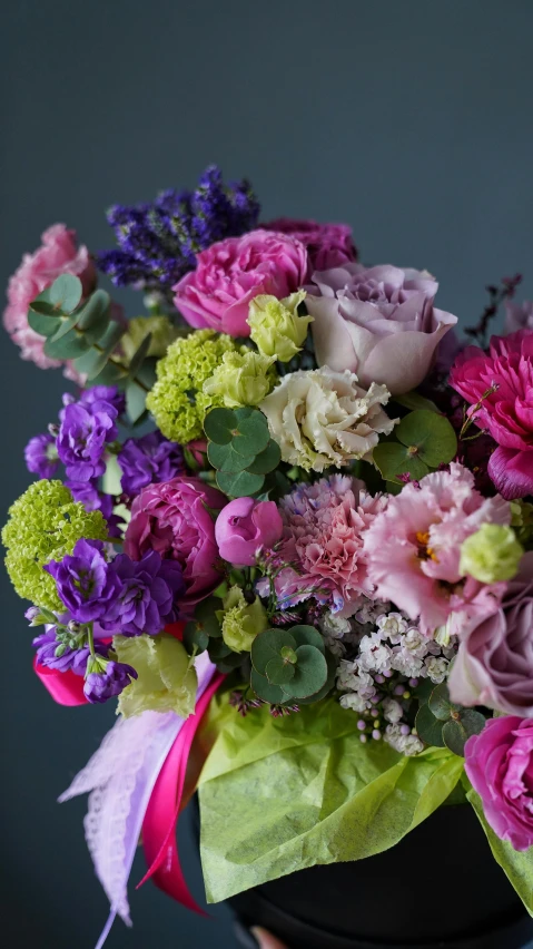 a close up of a person holding a vase of flowers, inspired by François Boquet, romanticism, lime and violet, vibrant pink, full of colour, on grey background