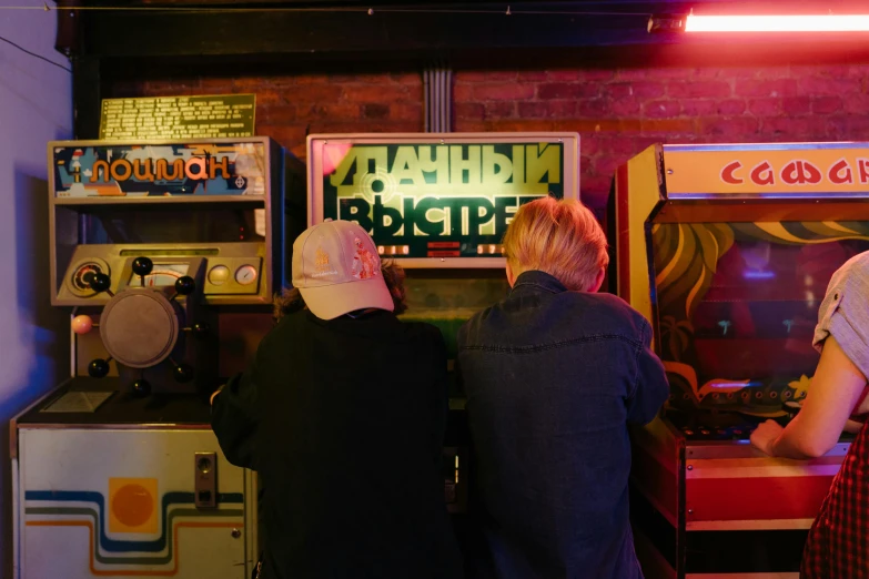 a couple of people that are playing a game, unsplash, private press, 1980s arcade, inside a bar, maxim sukharev, 2 5 6 x 2 5 6 pixels