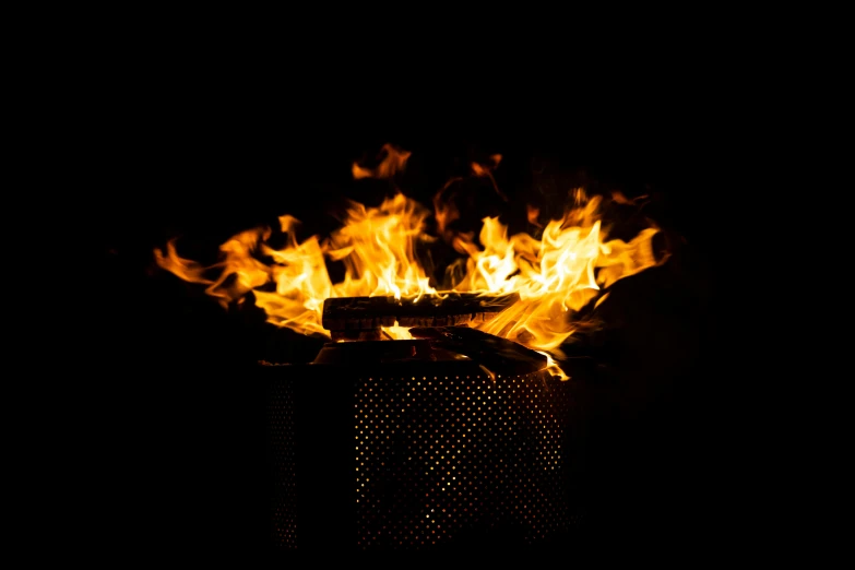 a fire burning in a trash can in the dark, an album cover, by Matthias Stom, pexels, visual art, the fire is made of binary code, fire pit, closeup shot, avatar image