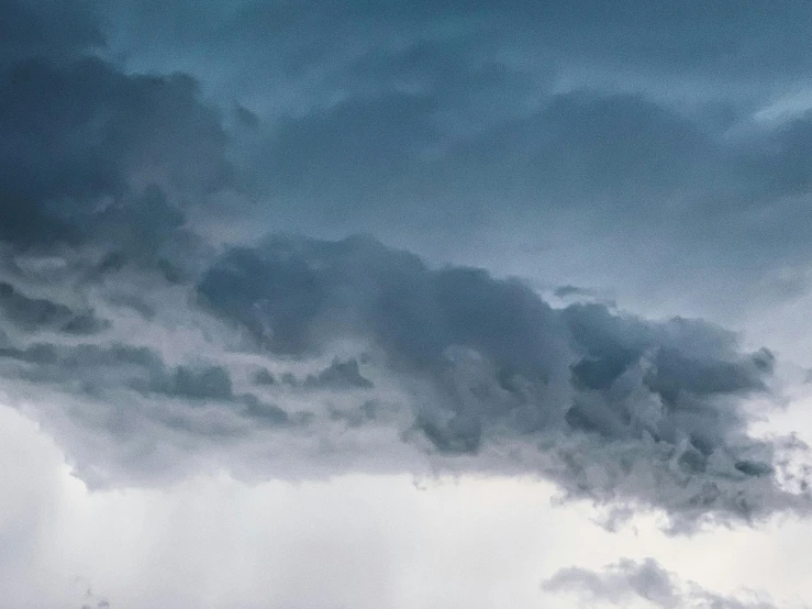 a jetliner flying through a cloudy sky, by Adam Marczyński, pexels contest winner, romanticism, hyperdetailed storm clouds, seen from below, panorama view of the sky, blue and gray colors