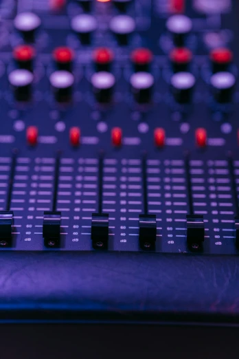 a sound mixer sitting on top of a table, by Dan Content, pexels, purple and red, panel of black, small red lights, background image