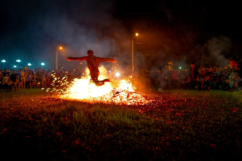 a man jumping over a fire in the middle of a field, happening, celebrating day of the dead, university, avatar image, trending photo