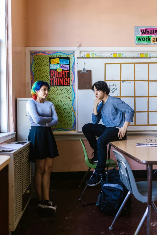 a group of people sitting around a table in a classroom, a portrait, trending on pexels, ashcan school, finn wolfhard, portrait of two people, 15081959 21121991 01012000 4k, wide full body