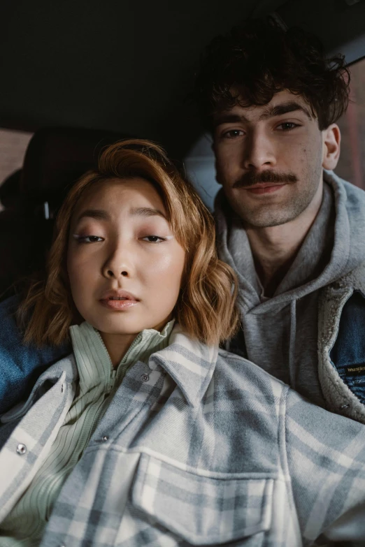 a man and a woman sitting in a car, a portrait, inspired by Jeremy Chong, trending on pexels, grey jacket, ashteroth, lee madgwick & liam wong, casual pose