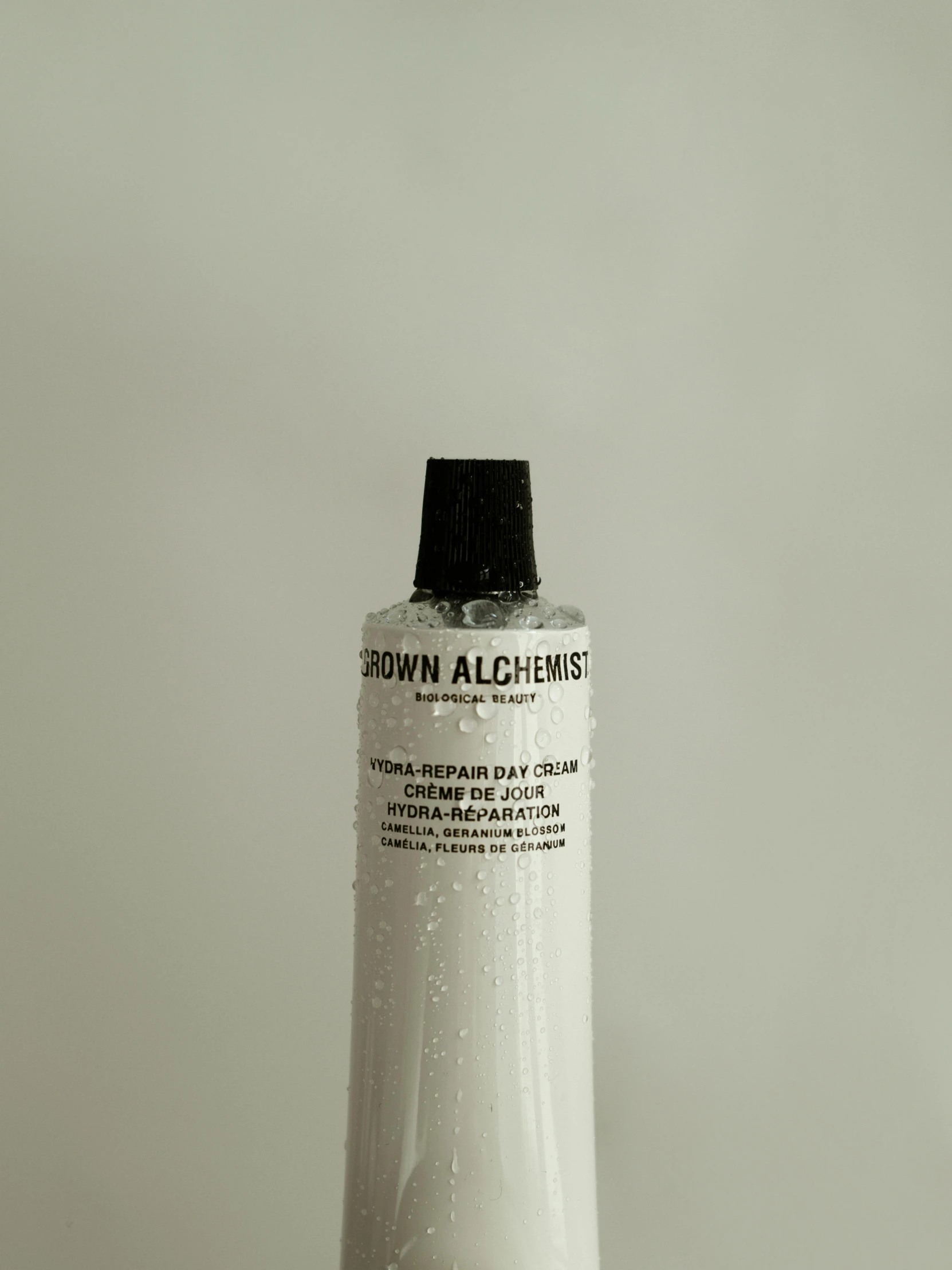 a tube of white paint sitting on top of a table, bauhaus, with textured hair and skin, cloud day, akiman, brown