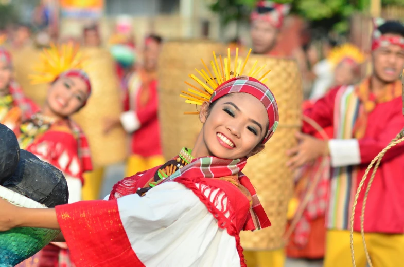 a group of people that are standing in the street, by Bernardino Mei, pexels contest winner, dau-al-set, tribal dance, philippines, smiling and dancing, wearing an elegant tribal outfit