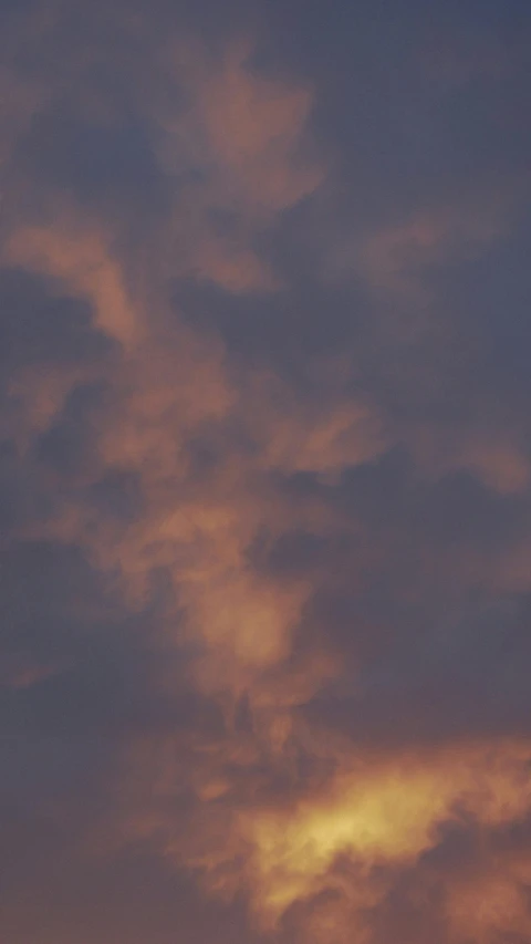 a large jetliner flying through a cloudy sky, a picture, by Anson Maddocks, at gentle dawn pink light, obscured underexposed view, cloud in the shape of a dragon, zoomed in