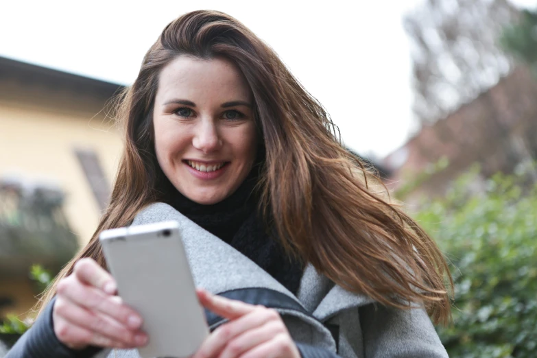 a close up of a person holding a cell phone, a picture, attractive brown hair woman, uploaded, guide, student