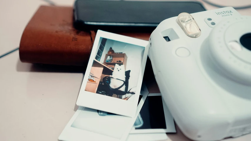 a polaroid camera sitting on top of a table, a polaroid photo, trending on pexels, computer art, cat photo, scrolling computer mouse, glossy white, product introduction photo