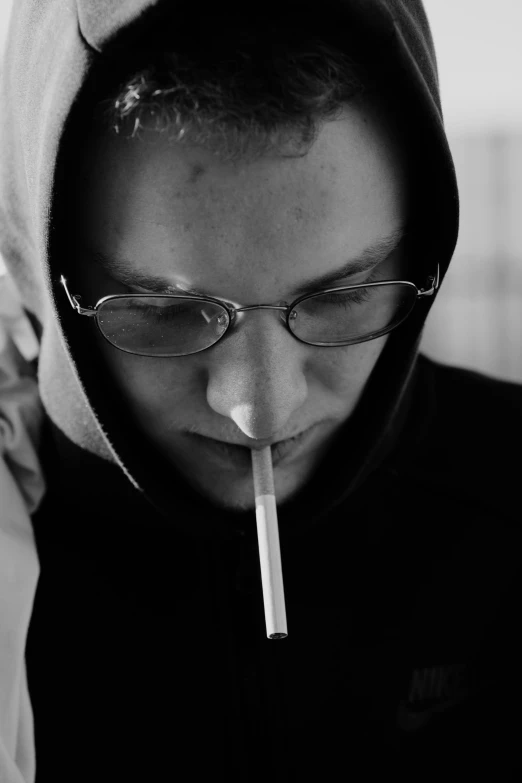 a black and white photo of a man with a cigarette in his mouth, inspired by Jan Rustem, wearing a hoody, homestuck, arthur clarke, praying with tobacco