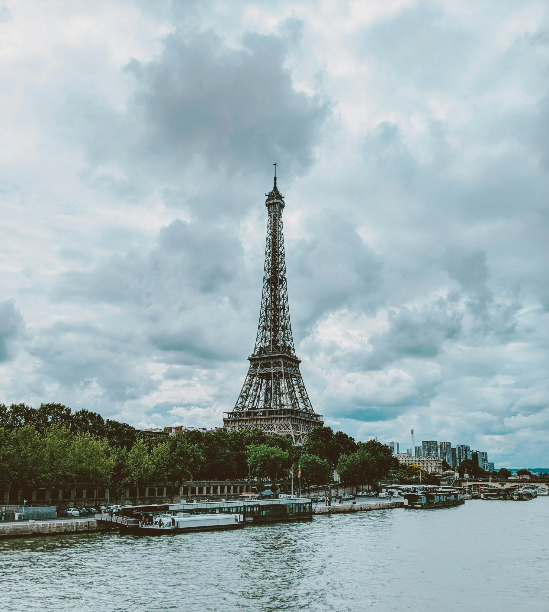 a view of the eiffel tower from across the river, pexels contest winner, overcast gray skies, today\'s featured photograph 4k, multiple stories, a small