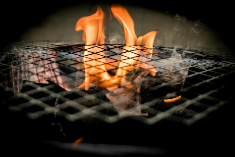 a close up of a grill with flames on it, by Joe Bowler, hurufiyya, a high angle shot, thumbnail, smoke from mouth, profile image