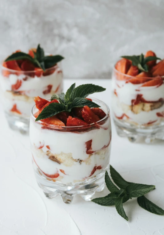 three glasses filled with yogurt and strawberries, unsplash, renaissance, smoked layered, sea of parfait, angle view, hips