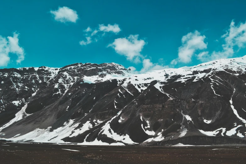 a large mountain covered in snow under a blue sky, by Julia Pishtar, pexels contest winner, slightly tanned, grey, 1 2 9 7, icelandic valley