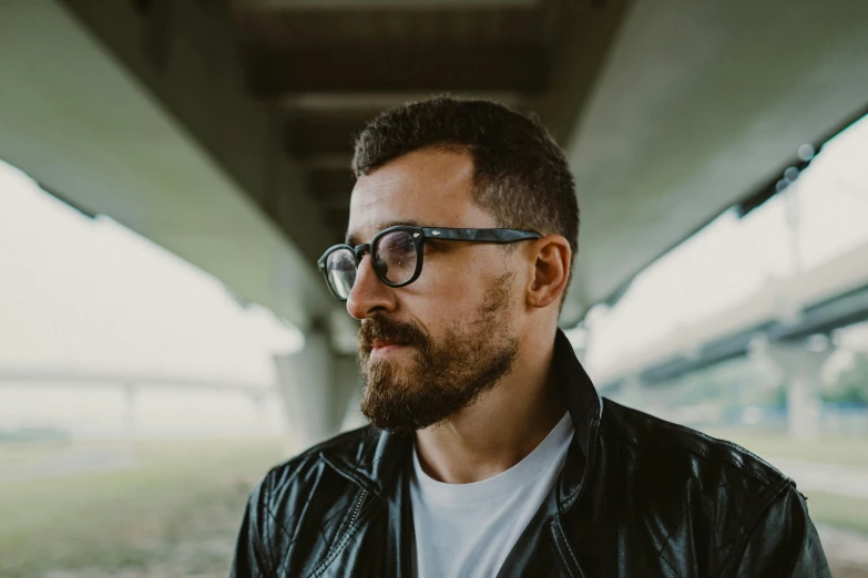 a man wearing glasses and a leather jacket, pexels contest winner, photo of džesika devic, thin beard, avatar image, square rimmed glasses