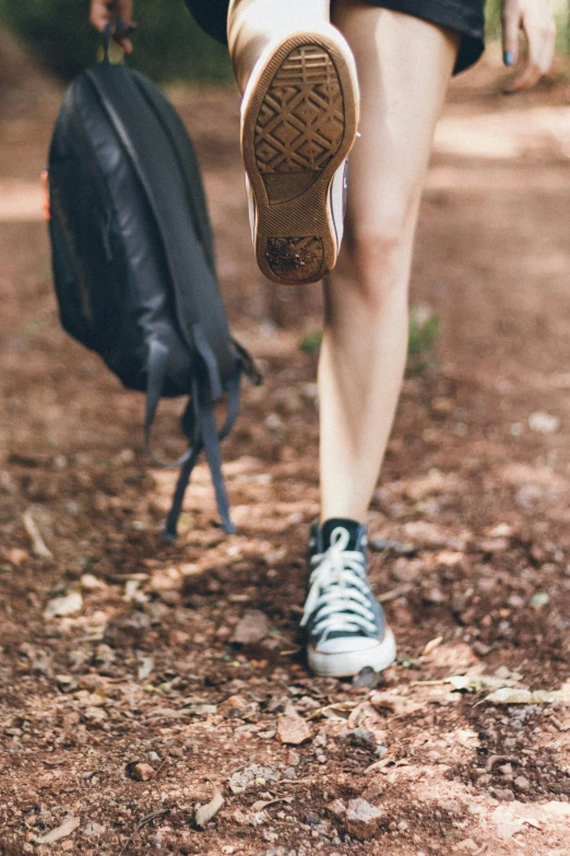 a woman walking in the woods with a backpack, pexels contest winner, happening, shows a leg, high school, tiny details, camp