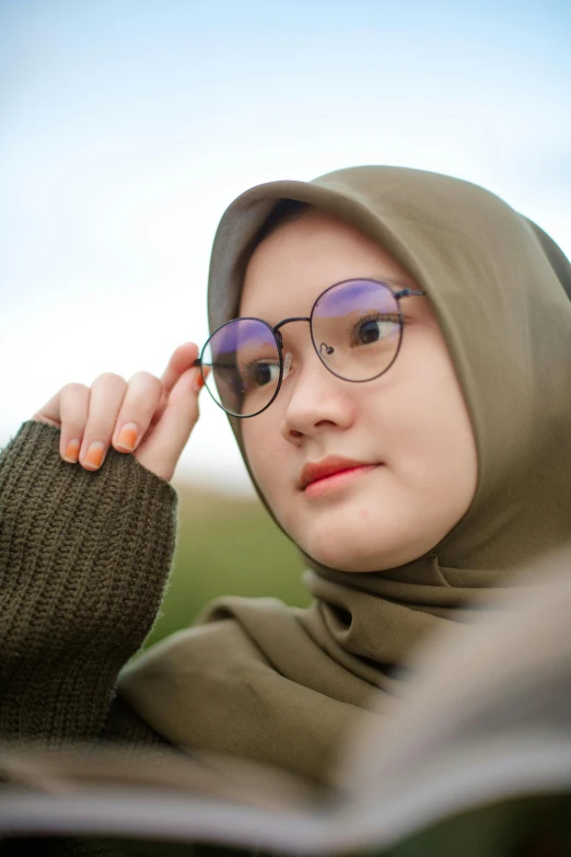 a woman wearing glasses is reading a book, inspired by Bernardino Mei, realism, malaysian, 2019 trending photo, square, 8 k what